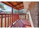Enjoy outdoor living on this covered porch with red painted wood and brick accents at 8554 Taylor Rd, Riverdale, GA 30274
