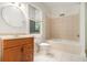 Bathroom with a combined tub and shower, a round mirror, and updated fixtures at 1065 Wylie Se St, Atlanta, GA 30316