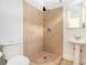 Bathroom featuring a tiled shower, a pedestal sink, and updated fixtures at 1065 Wylie Se St, Atlanta, GA 30316