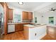 Kitchen with wooden cabinets, an island cooktop, and stainless steel appliances at 1065 Wylie Se St, Atlanta, GA 30316