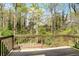 Wooden back deck overlooking a lush, wooded backyard offers a private outdoor retreat at 133 Cross Gate Dr, Marietta, GA 30068