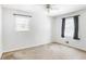 Bright bedroom with neutral walls, carpet, and two windows with dark curtains at 133 Cross Gate Dr, Marietta, GA 30068