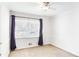Bedroom featuring neutral walls, carpeting, and a large window with dark curtains at 133 Cross Gate Dr, Marietta, GA 30068