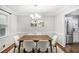 Dining room with table, chandelier, stainless steel refrigerator, and ample natural light at 133 Cross Gate Dr, Marietta, GA 30068