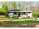 Charming, light grey split-level home with lush, green front yard and mature trees at 133 Cross Gate Dr, Marietta, GA 30068