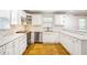 Bright kitchen featuring white cabinets, stainless steel appliances, and stylish backsplash at 133 Cross Gate Dr, Marietta, GA 30068