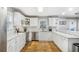 Modern kitchen with white cabinets, marble countertops, stainless steel appliances, and hardwood floors at 133 Cross Gate Dr, Marietta, GA 30068