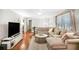 Spacious living room with a plush sectional sofa, hardwood floors, and natural light at 133 Cross Gate Dr, Marietta, GA 30068