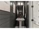 Chic half-bathroom with dark walls, pedestal sink, and modern lighting at 228 Idylwilde Way, Canton, GA 30115