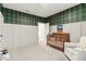 Bright bedroom with paneled wall, plush carpet and wood crib at 228 Idylwilde Way, Canton, GA 30115