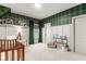 Bedroom with plaid wallpaper, white wainscoting, and adjoining full bathroom at 228 Idylwilde Way, Canton, GA 30115