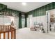 Bedroom with plaid wallpaper, white wainscoting, and adjoining full bathroom at 228 Idylwilde Way, Canton, GA 30115