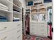 Spacious walk in closet featuring custom shelving, drawers, and carpet at 228 Idylwilde Way, Canton, GA 30115