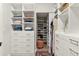 Organized walk in closet with custom shelves, drawers, and an ottoman at 228 Idylwilde Way, Canton, GA 30115