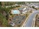 Aerial view of the community pool, garden and clubhouse surrounded by evergreen trees in a well-planned neighborhood at 228 Idylwilde Way, Canton, GA 30115