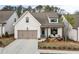 Beautifully designed cottage with a two-car garage, covered porch, and inviting curb appeal at 228 Idylwilde Way, Canton, GA 30115