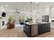 Open-concept kitchen with dark island, stainless appliances, and a view into the living area at 228 Idylwilde Way, Canton, GA 30115