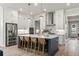 Spacious kitchen featuring an island with seating, stainless steel appliances, and white cabinetry at 228 Idylwilde Way, Canton, GA 30115