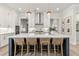 Open-concept kitchen with a large island, marble countertops, pendant lighting, and stainless steel appliances at 228 Idylwilde Way, Canton, GA 30115