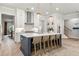 Modern kitchen with a large island, stainless steel appliances, and a view of the staircase at 228 Idylwilde Way, Canton, GA 30115