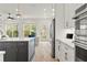 Bright, open kitchen with island, stainless appliances, and access to the backyard at 228 Idylwilde Way, Canton, GA 30115