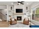 Cozy living room with fireplace, built-in shelving, and comfortable leather chairs at 228 Idylwilde Way, Canton, GA 30115