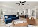 Spacious open-concept living room and kitchen with dark island and barstool seating at 228 Idylwilde Way, Canton, GA 30115