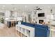 Bright living room flows into kitchen with island seating, fireplace, and modern design at 228 Idylwilde Way, Canton, GA 30115