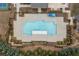 Aerial shot of a large pool with a concrete deck surrounded by greenery and a dark metal fence at 228 Idylwilde Way, Canton, GA 30115