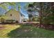 A side view of a home with a large yard surrounded by beautiful mature trees at 4070 Amber Leaf Dr, Roswell, GA 30076