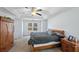 Comfortable bedroom with ceiling fan, carpet floors, and ample natural light from the large window at 4070 Amber Leaf Dr, Roswell, GA 30076