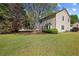 Manicured lawn and lush landscaping featuring mature trees and a partial view of the house at 4070 Amber Leaf Dr, Roswell, GA 30076