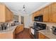Efficient kitchen featuring granite countertops, a suite of modern appliances, and beautiful wooden cabinets at 4070 Amber Leaf Dr, Roswell, GA 30076