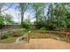 Wooden deck overlooking a well-maintained backyard with mature landscaping and brick-lined paths at 873 Monroe Ne Cir, Atlanta, GA 30308