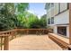 A backyard deck featuring sunburst wood accents and view of the landscaped yard and exterior fireplace at 873 Monroe Ne Cir, Atlanta, GA 30308