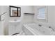 Bright bathroom featuring a jetted tub, a vanity, and stylish tile flooring at 873 Monroe Ne Cir, Atlanta, GA 30308