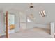 Cozy bedroom with carpet, skylights, and a ceiling fan leading to an ensuite bathroom at 873 Monroe Ne Cir, Atlanta, GA 30308