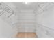 Walk-in closet features multiple shelves for optimal storage in a simple design at 873 Monroe Ne Cir, Atlanta, GA 30308