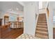 Inviting entryway with stairs to upper level and a view of the open kitchen with breakfast bar seating at 873 Monroe Ne Cir, Atlanta, GA 30308