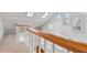 Hallway featuring a wooden railing, multiple skylights, and hardwood floors below at 873 Monroe Ne Cir, Atlanta, GA 30308