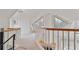 Bright hallway featuring hardwood railings, carpet floors and unique triangle windows at 873 Monroe Ne Cir, Atlanta, GA 30308