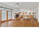 Open concept kitchen and living room area featuring a brick fireplace, bar seating, and hardwood floors at 873 Monroe Ne Cir, Atlanta, GA 30308