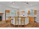 Well-lit kitchen with bar seating, modern appliances, and bright white walls in an open concept layout at 873 Monroe Ne Cir, Atlanta, GA 30308