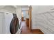 Convenient laundry area with modern washer and dryer, ample shelving, and views to kitchen at 873 Monroe Ne Cir, Atlanta, GA 30308