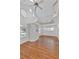 Bright living room with hardwood floors, high ceilings, a modern ceiling fan, and many windows at 873 Monroe Ne Cir, Atlanta, GA 30308