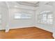 Spacious living room featuring hardwood floors, white walls, large windows, and an open floor plan at 873 Monroe Ne Cir, Atlanta, GA 30308