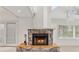 Living room featuring a marble fireplace, French doors, and vaulted ceilings at 873 Monroe Ne Cir, Atlanta, GA 30308