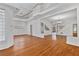 Large living room featuring hardwood floors, white walls, large windows, staircase and chandelier at 873 Monroe Ne Cir, Atlanta, GA 30308