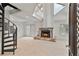 Living room featuring a fireplace, a spiral staircase, and large windows at 873 Monroe Ne Cir, Atlanta, GA 30308