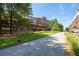 Picturesque outdoor space featuring a concrete path, green lawns, modern architecture, and mature trees at 873 Monroe Ne Cir, Atlanta, GA 30308